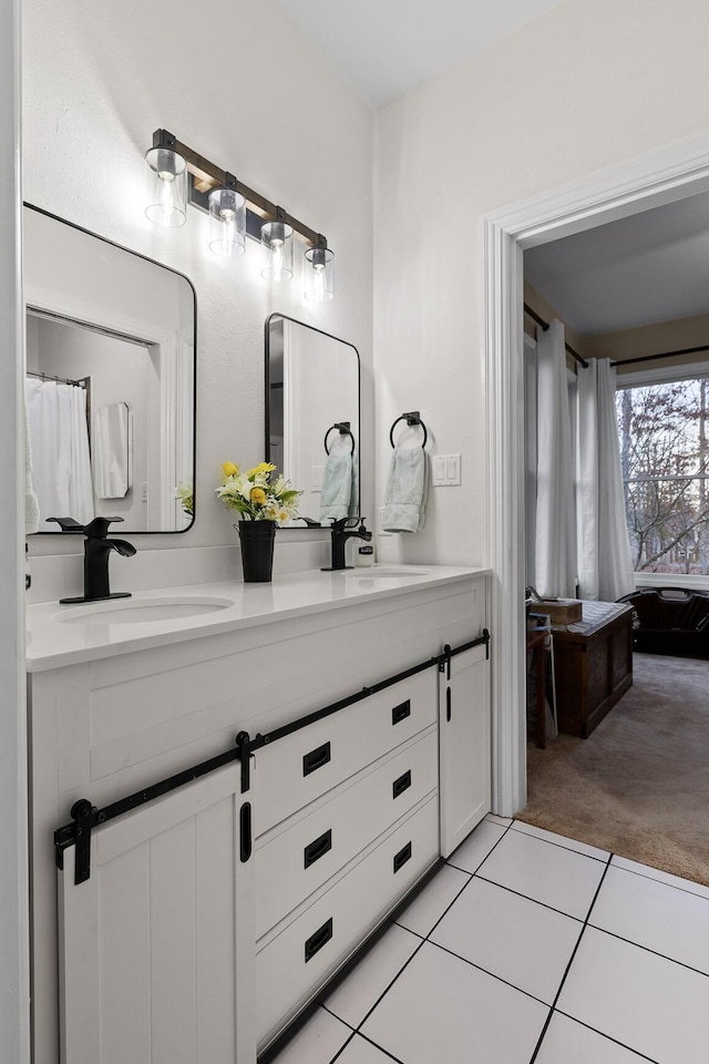 full bathroom with tile patterned flooring, double vanity, and a sink