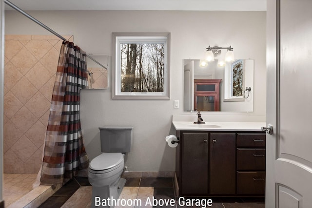 bathroom with a shower stall, vanity, and toilet