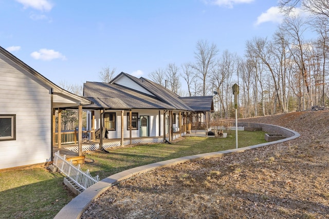 exterior space with a yard and a shingled roof