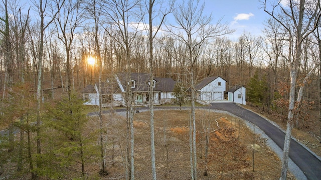 view of front of house with aphalt driveway and a detached garage