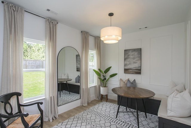 interior space featuring a wealth of natural light, visible vents, and light wood-type flooring