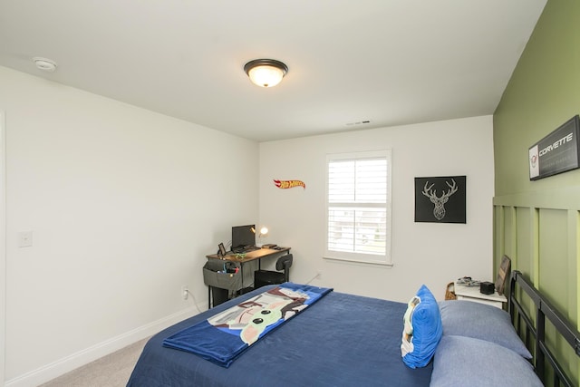 carpeted bedroom with visible vents and baseboards