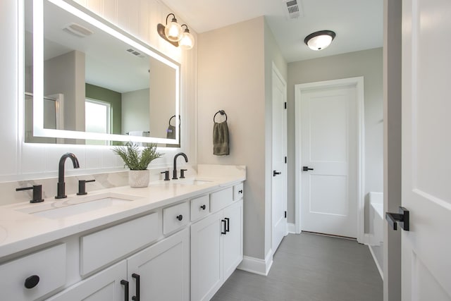 full bath featuring a sink and visible vents