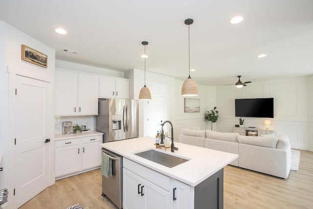 kitchen featuring a sink, ceiling fan, stainless steel appliances, white cabinets, and visible vents