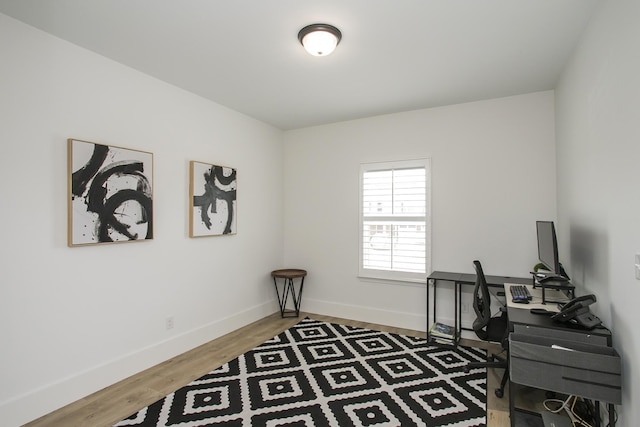 home office with wood finished floors and baseboards