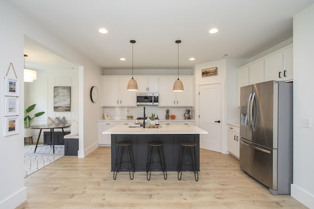 kitchen with light countertops, appliances with stainless steel finishes, and white cabinets