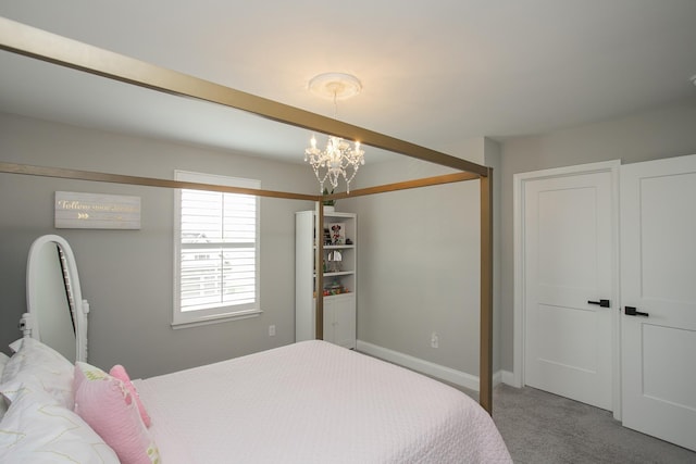 bedroom featuring a chandelier, carpet floors, and baseboards