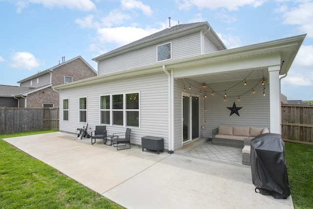 rear view of property featuring a patio area, a fenced backyard, and an outdoor hangout area