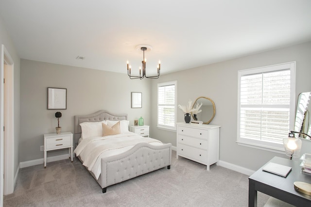 bedroom with visible vents, baseboards, an inviting chandelier, and light colored carpet