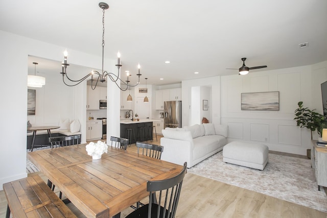 dining room with a ceiling fan, visible vents, recessed lighting, and light wood-style floors