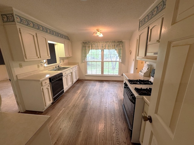 kitchen featuring black dishwasher, a sink, light countertops, white cabinetry, and gas stove