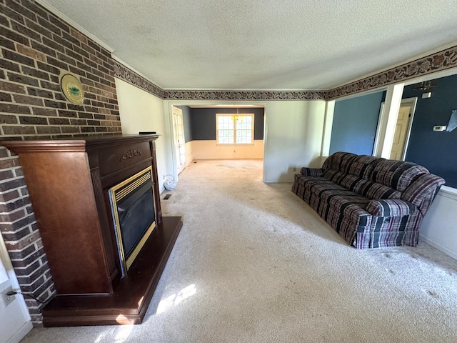 carpeted living room with a glass covered fireplace and a textured ceiling