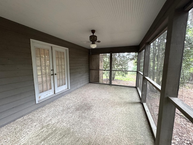 unfurnished sunroom with french doors, a ceiling fan, and a healthy amount of sunlight