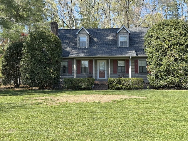 cape cod home featuring a front yard, roof with shingles, and a chimney