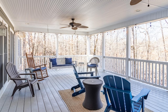 wooden deck featuring ceiling fan