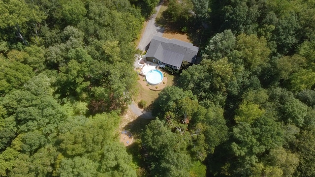 birds eye view of property featuring a view of trees