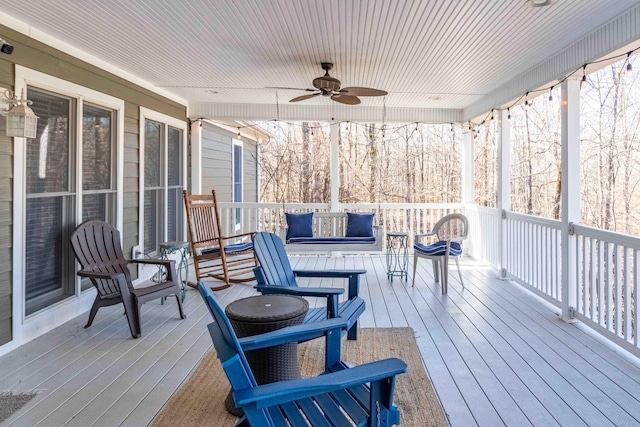 wooden terrace with a ceiling fan