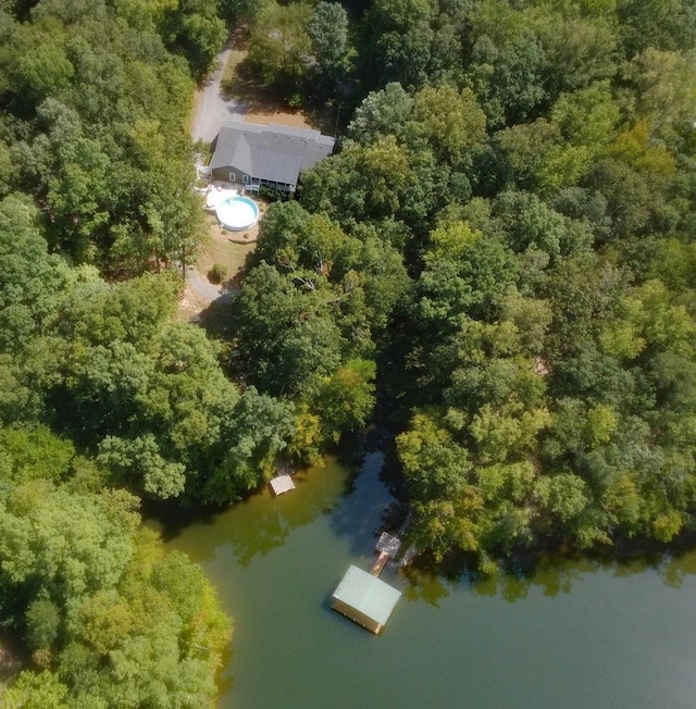 bird's eye view with a wooded view and a water view