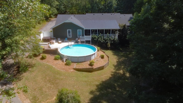pool with a yard and a patio