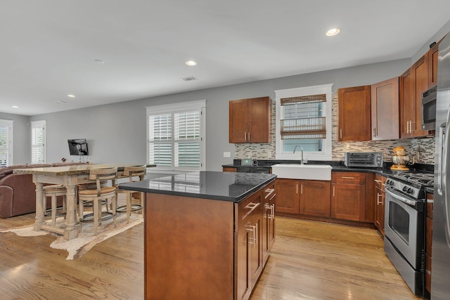613 Chesterfield Way, Nashville, TN 37212 - kitchen featuring a center island, a sink, backsplash, and stainless steel appliances