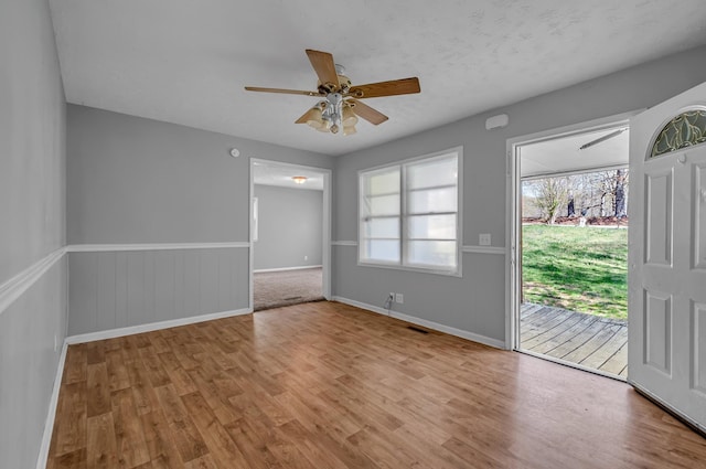 1425 Wesley Rd, Bon Aqua, TN 37025 - interior space with access to outside, a ceiling fan, visible vents, wood finished floors, and wainscoting