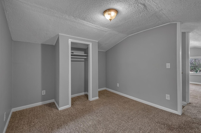 1425 Wesley Rd, Bon Aqua, TN 37025 - unfurnished bedroom with a closet, baseboards, vaulted ceiling, carpet flooring, and a textured ceiling