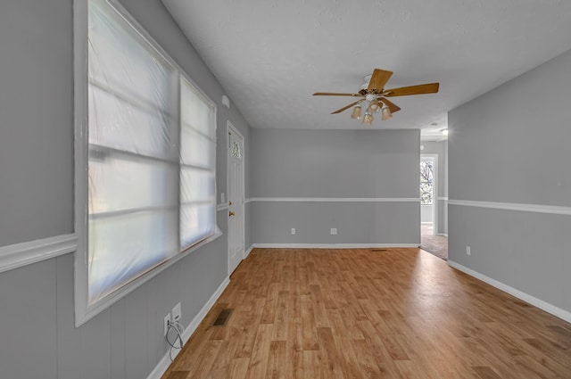 1425 Wesley Rd, Bon Aqua, TN 37025 - unfurnished room featuring light wood-style floors, ceiling fan, baseboards, and visible vents