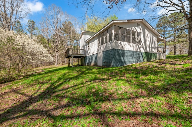 1425 Wesley Rd, Bon Aqua, TN 37025 - view of property exterior featuring a yard, a wooden deck, and a sunroom