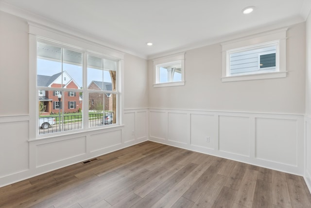 7930 Pine St, Fairview, TN 37062 - empty room with a decorative wall, wainscoting, visible vents, and wood finished floors