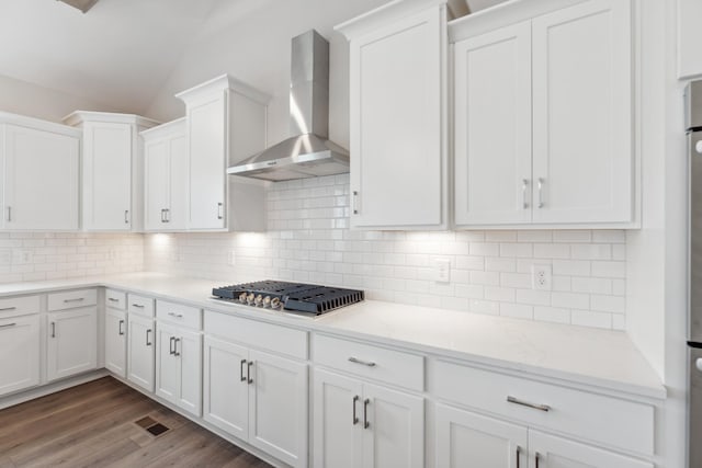 7930 Pine St, Fairview, TN 37062 - kitchen featuring tasteful backsplash, wall chimney range hood, stainless steel gas stovetop, vaulted ceiling, and white cabinets