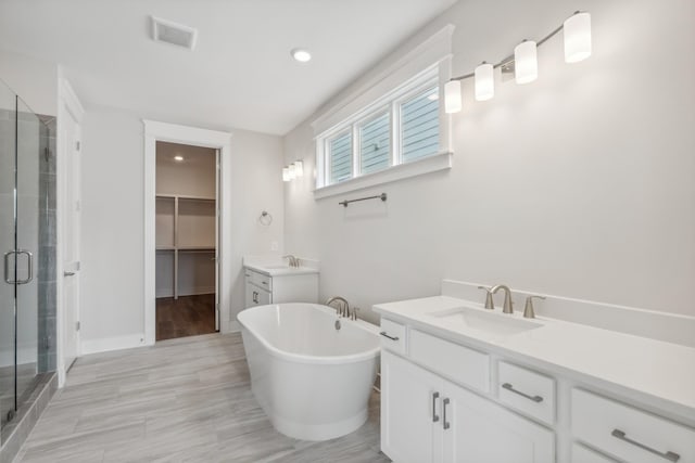 7930 Pine St, Fairview, TN 37062 - bathroom with a shower stall, vanity, visible vents, a walk in closet, and a freestanding bath