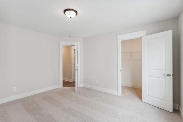 7930 Pine St, Fairview, TN 37062 - unfurnished bedroom with a closet, baseboards, a walk in closet, and light carpet