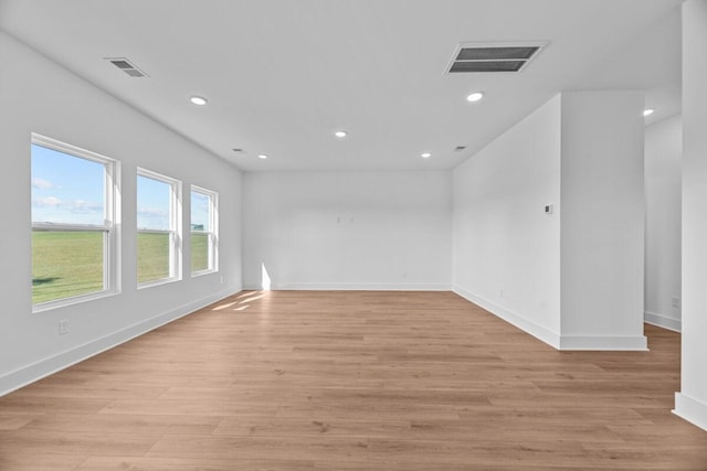 empty room with recessed lighting, baseboards, visible vents, and light wood-type flooring