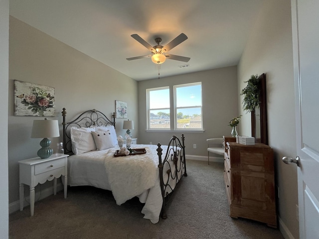 carpeted bedroom with visible vents, baseboards, and ceiling fan