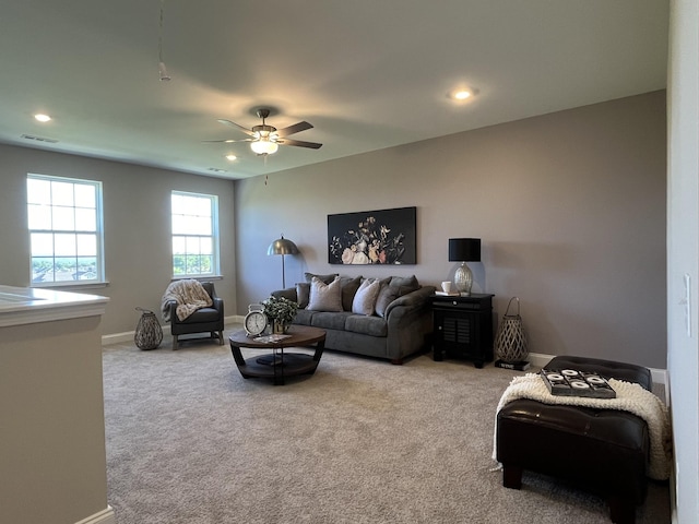carpeted living area featuring ceiling fan, baseboards, visible vents, and recessed lighting