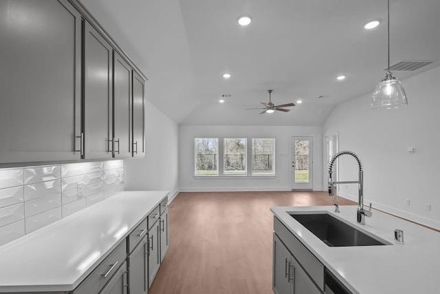 kitchen with vaulted ceiling, visible vents, a sink, and recessed lighting