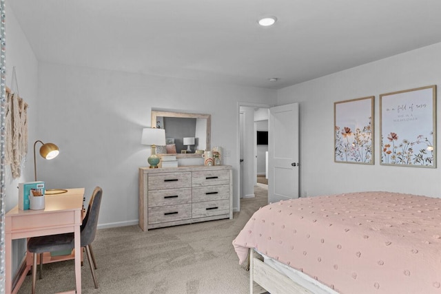 bedroom with light carpet and baseboards