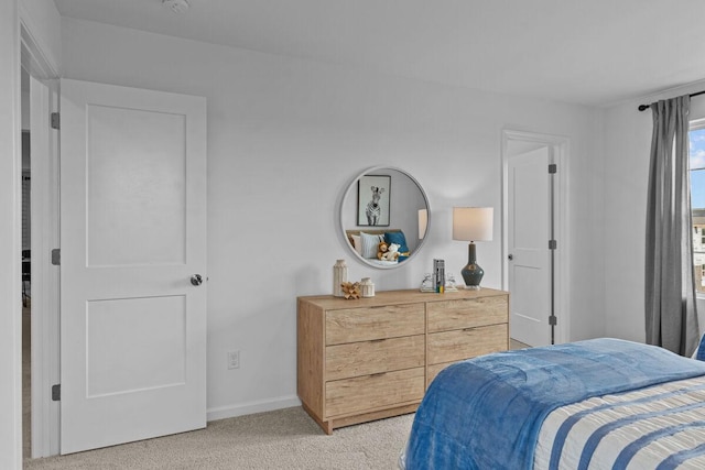 bedroom featuring baseboards and light carpet