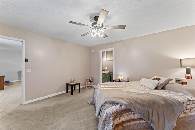 bedroom with light colored carpet, a ceiling fan, baseboards, and ensuite bath