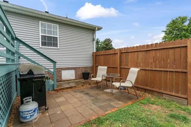 view of patio / terrace with area for grilling and fence