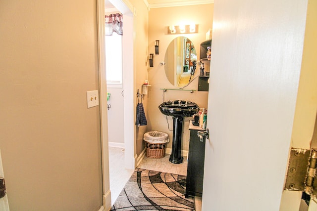 bathroom featuring crown molding and baseboards