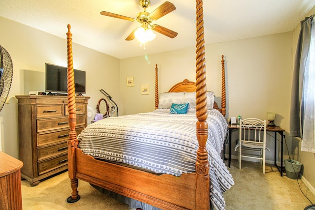 bedroom featuring light colored carpet and a ceiling fan