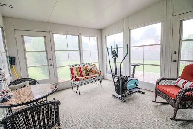 sunroom / solarium featuring carpet floors and french doors