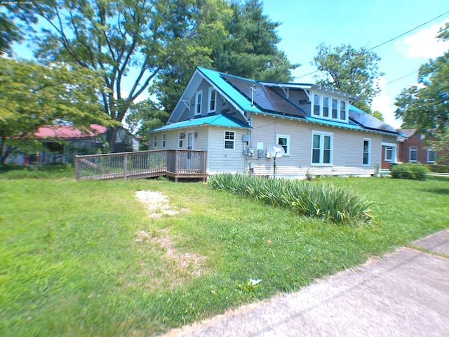 201 Hodges St N, Cowan, TN 37318 - view of front facade featuring a wooden deck, a front lawn, and a metal roof