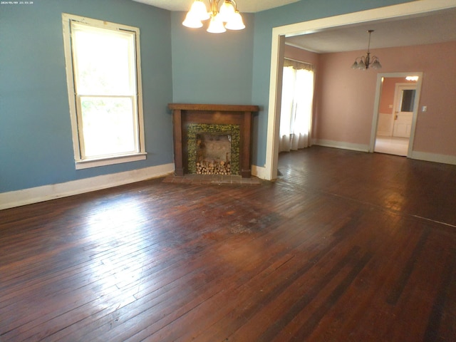 201 Hodges St N, Cowan, TN 37318 - unfurnished living room featuring a chandelier, healthy amount of natural light, wood-type flooring, and a tiled fireplace