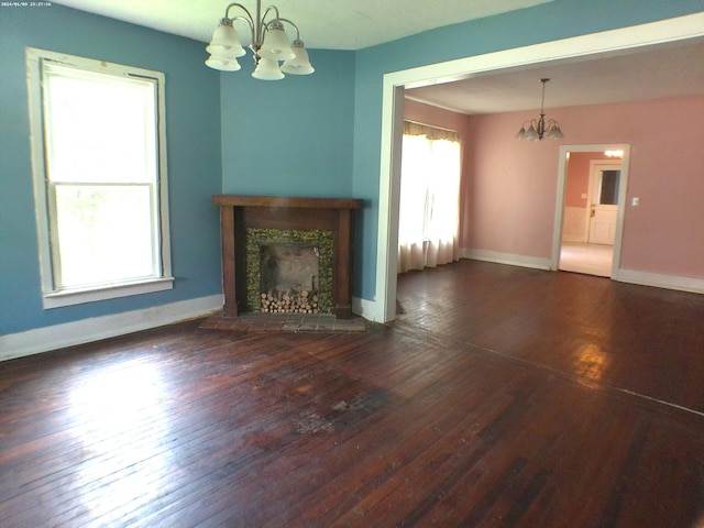 201 Hodges St N, Cowan, TN 37318 - unfurnished living room featuring a chandelier, wood-type flooring, and a tile fireplace
