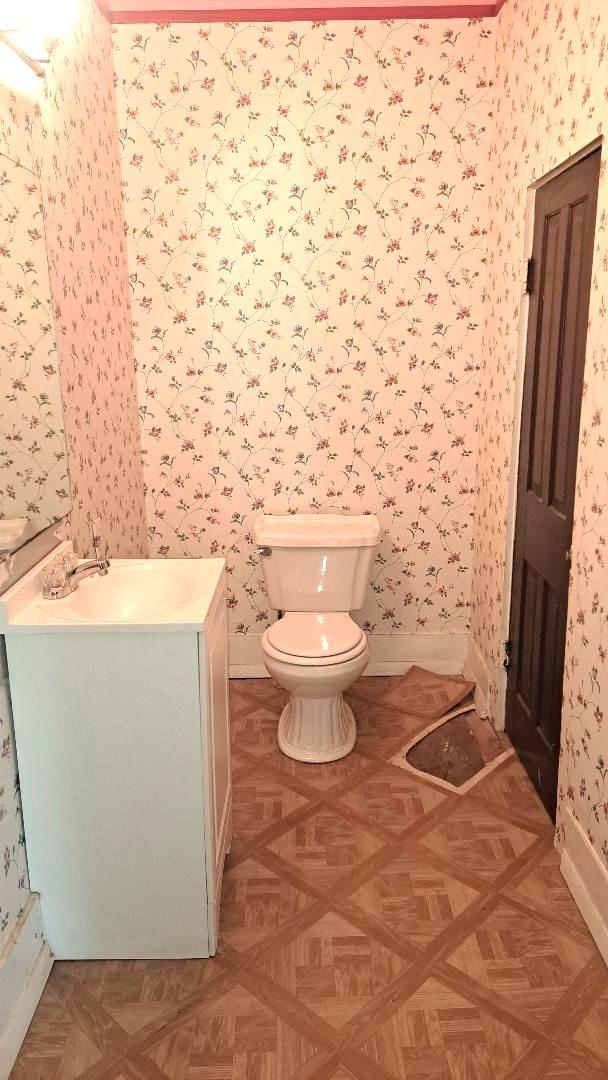 201 Hodges St N, Cowan, TN 37318 - bathroom featuring wallpapered walls and vanity