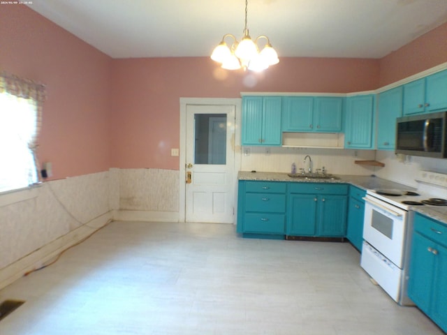 201 Hodges St N, Cowan, TN 37318 - kitchen with stainless steel microwave, white electric range oven, blue cabinetry, a chandelier, and a wainscoted wall