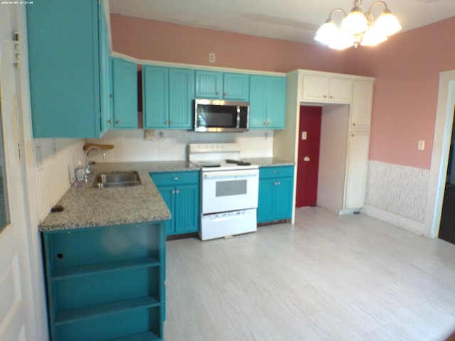 201 Hodges St N, Cowan, TN 37318 - kitchen with stainless steel microwave, electric range, blue cabinets, open shelves, and light wood finished floors
