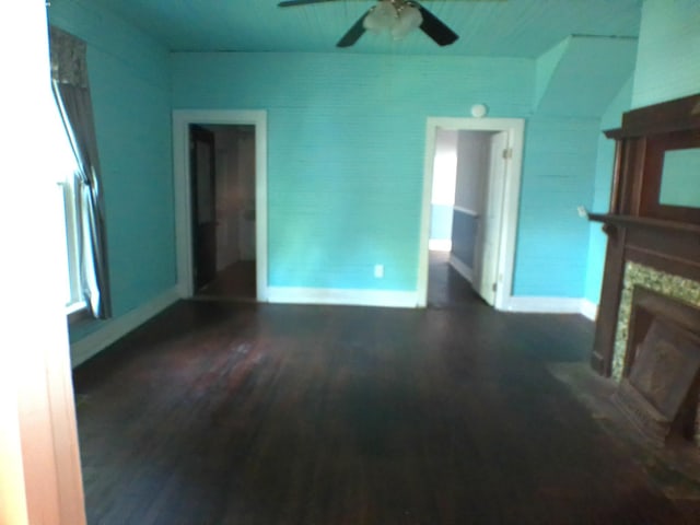 201 Hodges St N, Cowan, TN 37318 - unfurnished living room featuring wood finished floors, ceiling fan, and a stone fireplace
